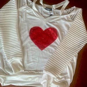 White blouse with large red heart in center.